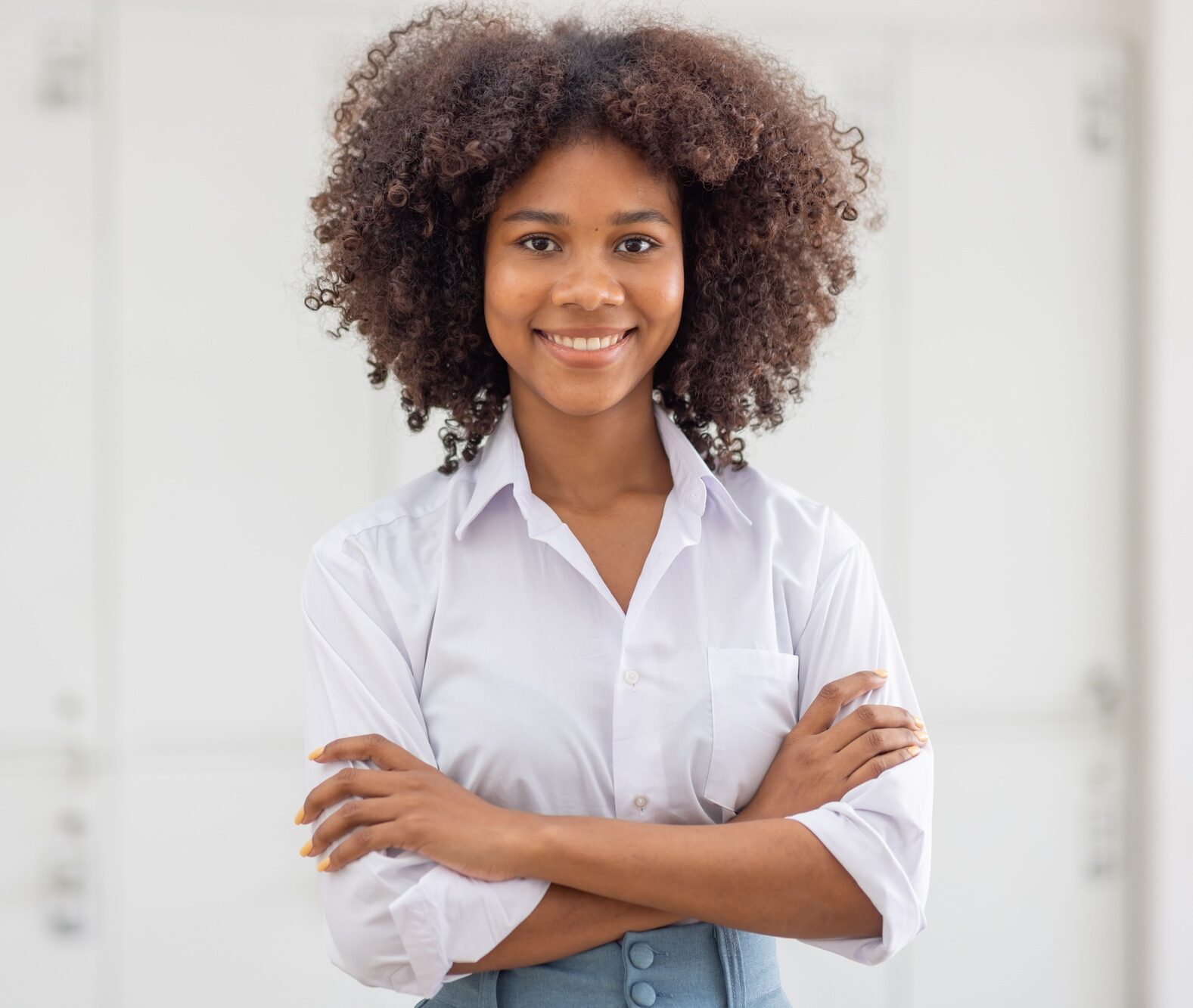 Female african american business woman in at the workplace, standing confidently. Attractive young